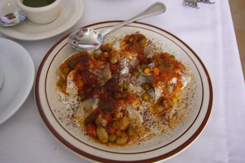 Representative photograph of Afghan Mantu. The photograph includes peas and a red sauce; this draft uses a yellow split-pea topping.