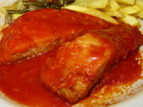 Representative photograph of Bacalao con Tomate. The photograph includes chips not included in this draft.