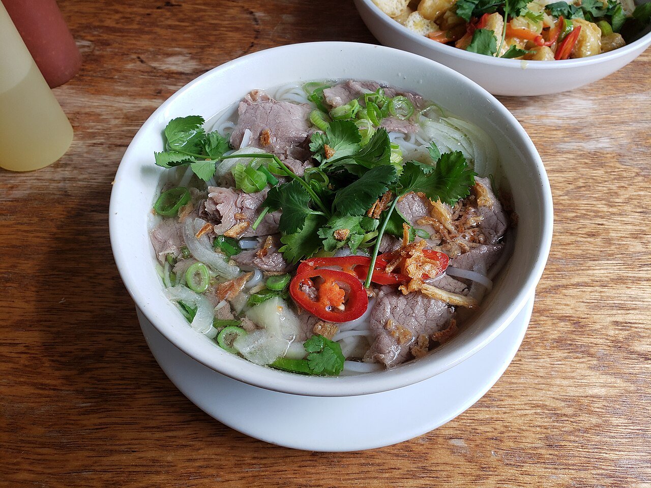 Representative photograph of Beef Pho. The photograph includes fresh chili garnish not included in this draft.