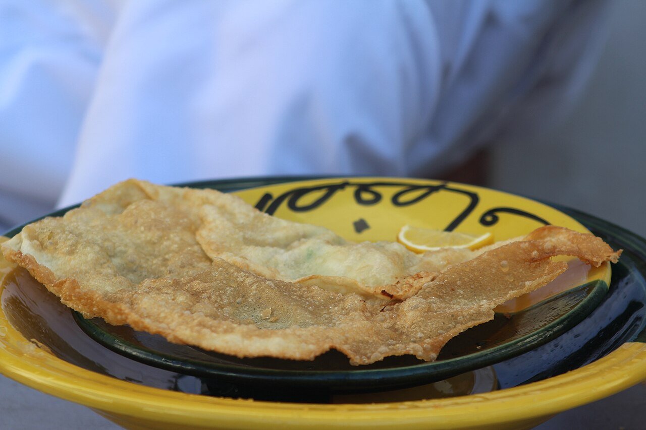 Representative photograph of Brik with Tuna. The source identifies brik but does not establish its filling. This draft uses tuna and egg.