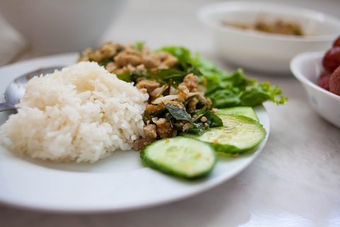 Representative photograph of Chicken Larb. The photo includes rice and cucumber accompaniments not included in this draft.