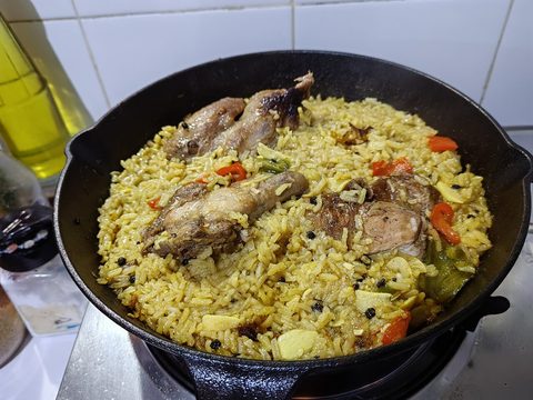 Representative photograph of Chicken Paella. The photograph uses larger bone-in chicken pieces and some different vegetables; this draft uses cubed thighs.