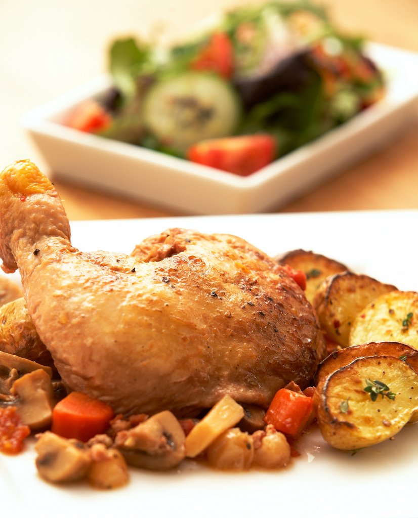 Representative photograph of Coq au Vin. The photograph includes side vegetables and a different-looking wine sauce; this draft uses red wine.