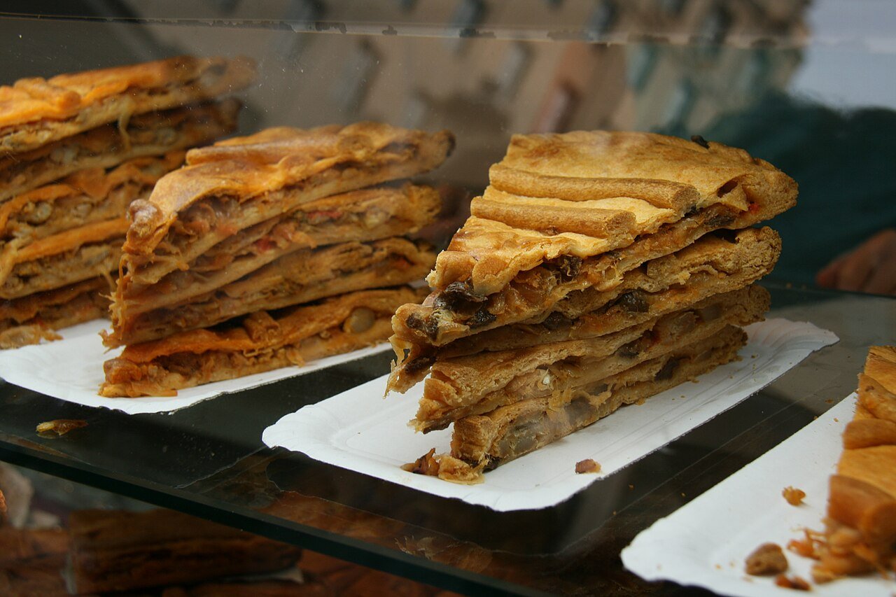 Representative photograph of Empanada Gallega. The source identifies Galician empanadas but does not identify the filling. This draft uses tuna.