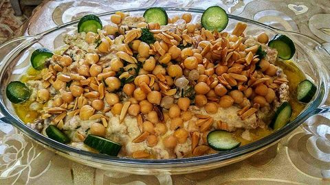 Representative photograph of Fatteh. The photo includes cucumber and nuts as garnish.