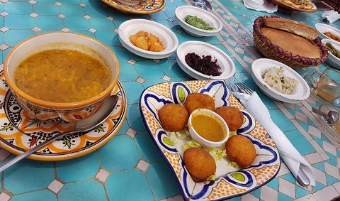 Representative photograph of Harira. The photograph includes pastries and accompaniments not included in this soup recipe.