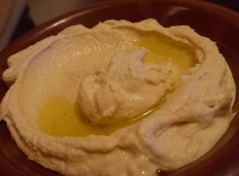 Hummus with olive oil in a shallow bowl