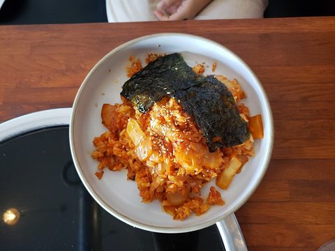 Representative photograph of Kimchi Fried Rice. The photograph includes nori and an egg topping not included in this draft.