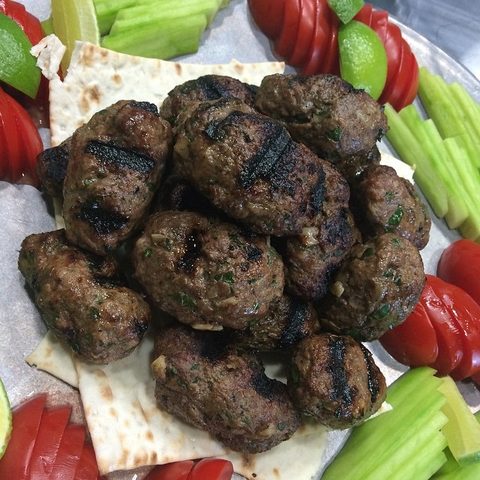 Representative photograph of Lamb Kofta. The photo shows grilled patties; shape the mixture as directed in this recipe.
