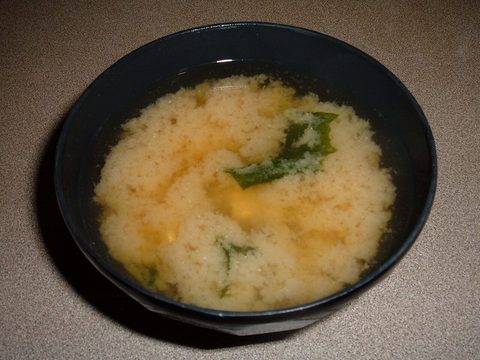 Miso soup with seaweed in a dark bowl