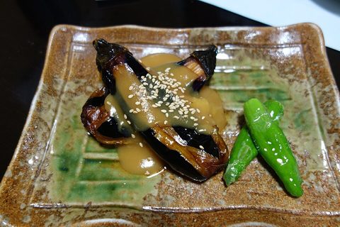 Representative photograph of Nasu Dengaku. The photo shows a plated aubergine portion with peppers.