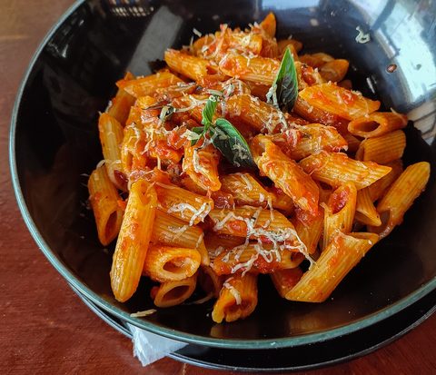 Representative photograph of Penne Arrabbiata. The photograph includes grated cheese not included in this draft.