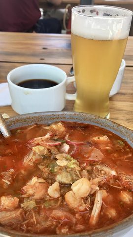 Representative photograph of Pozole Rojo. The photograph includes a drink not included in this draft.