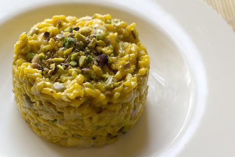 Representative photograph of Saffron Risotto. The photograph includes pistachio garnish not included in this draft.