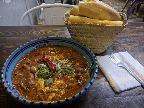 Representative photograph of Shakshuka with Merguez. The photograph includes bread and garnish not included in this draft.
