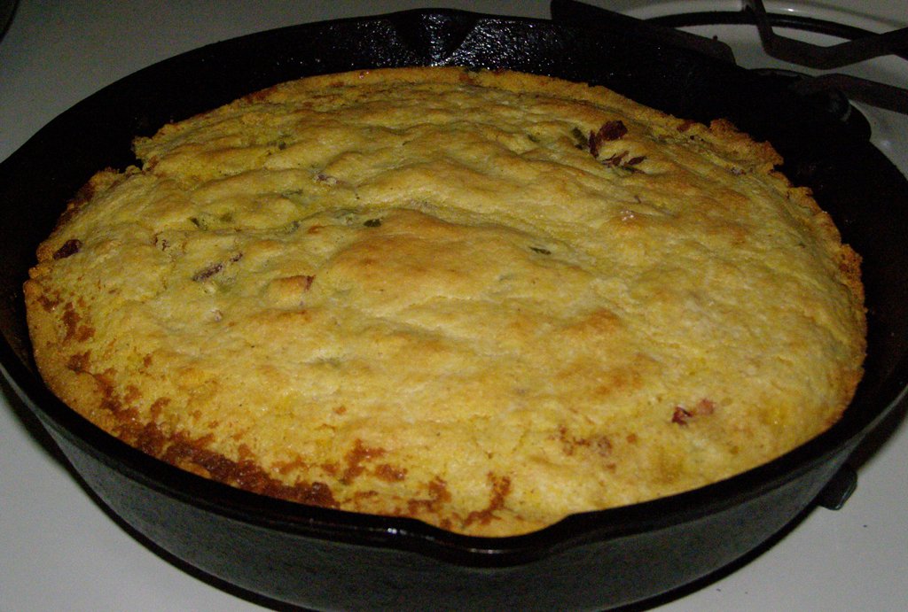 Representative photograph of Skillet Cornbread. The photograph includes visible green additions not included in this plain cornbread draft.