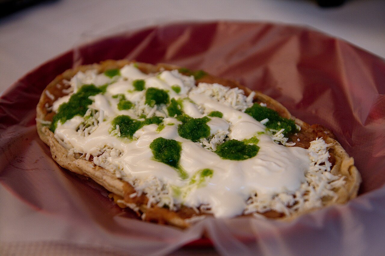 Representative photograph of Sopes. The photograph includes extra cream and cheese toppings that differ from this draft.