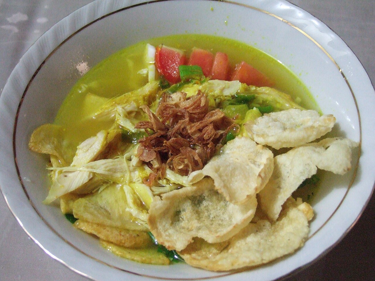 Representative photograph of Soto Ayam. The photograph includes crackers and fried shallots not included in this draft.