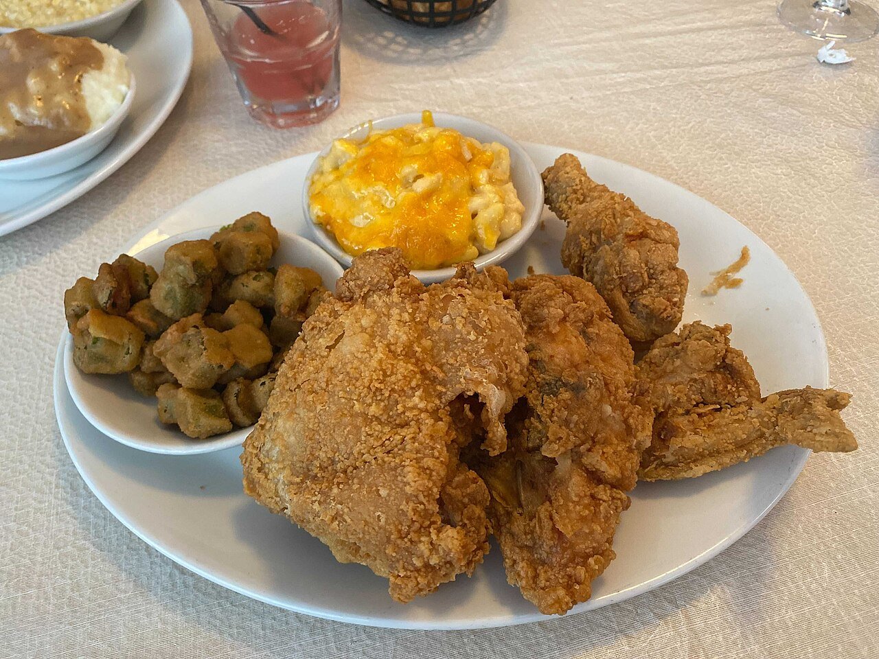 Representative photograph of Southern Fried Chicken. The photograph includes fried okra and macaroni cheese not included in this draft.