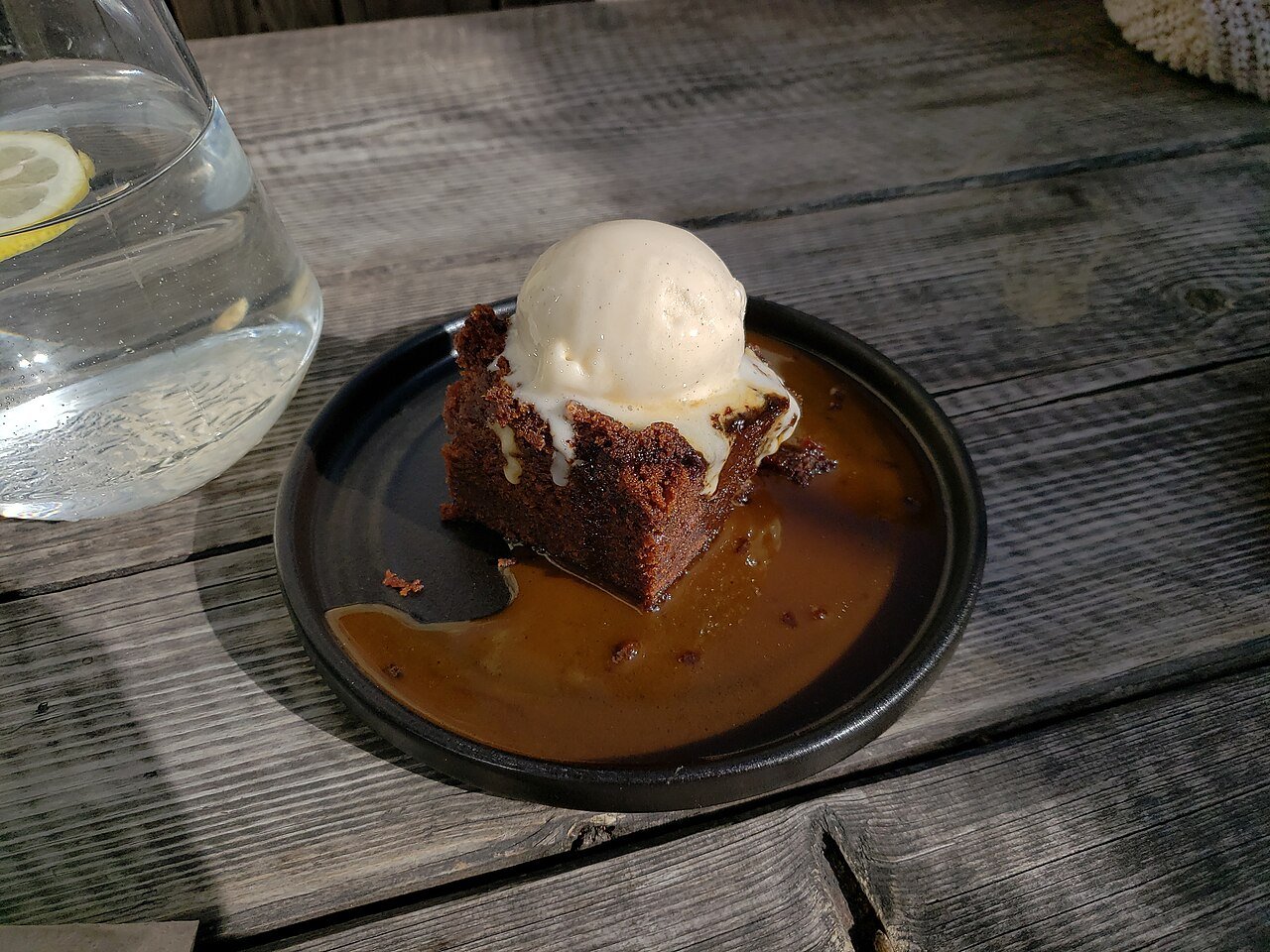 Representative photograph of Sticky Toffee Pudding. The photograph includes ice cream not included in this draft.
