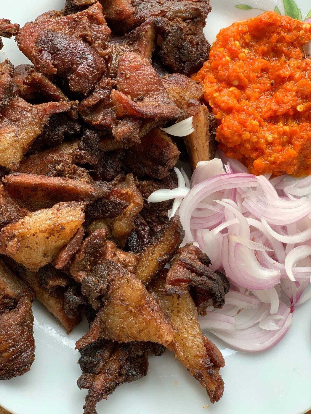 Representative photograph of Suya. The photograph includes onion and pepper sauce not included in this draft.