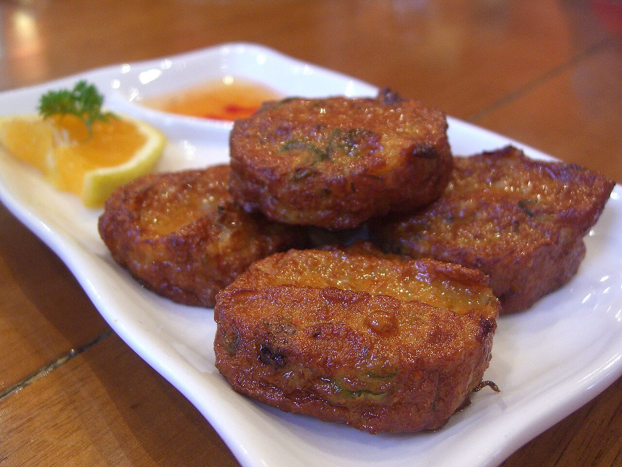 Representative photograph of Thai Fish Cakes. The photo includes dipping sauce and garnish not included in this draft.