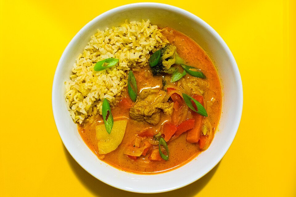 Representative photograph of Thai Red Vegetable Curry. The photo includes rice alongside the curry.