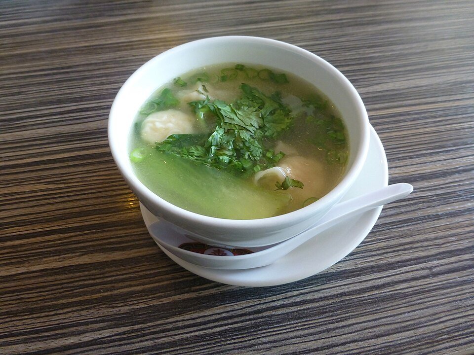 Representative photograph of Wonton Soup. The photo includes leafy greens.
